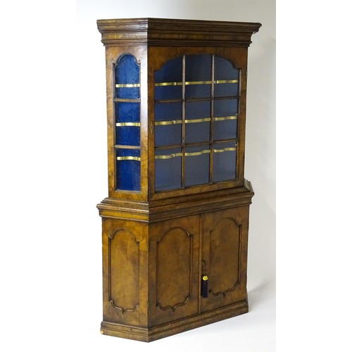 1499 - A late 19thC walnut cabinet with a moulded cornice above an astragal glazed door containing three pa... 