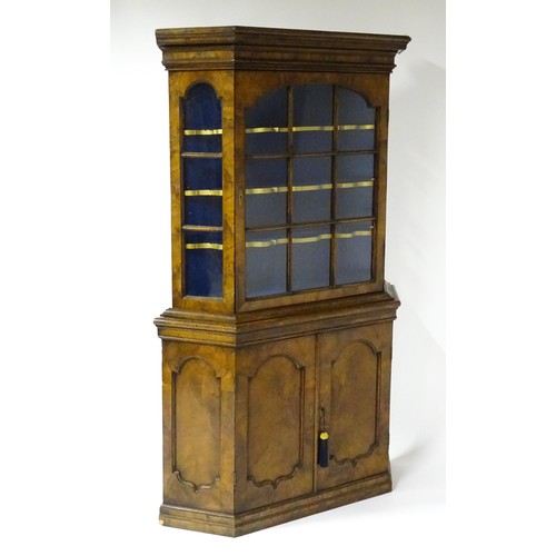 1499 - A late 19thC walnut cabinet with a moulded cornice above an astragal glazed door containing three pa... 