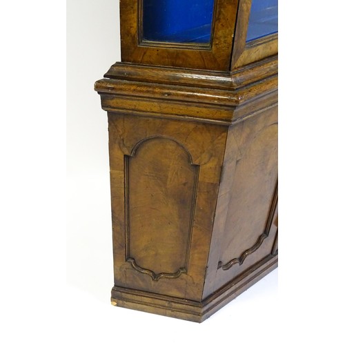 1499 - A late 19thC walnut cabinet with a moulded cornice above an astragal glazed door containing three pa... 