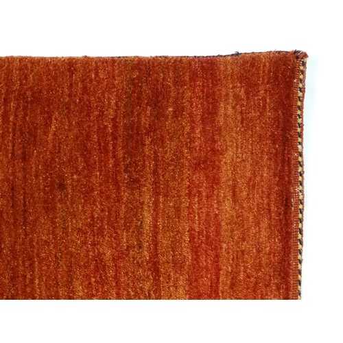 1350 - Carpet / Rug : A large carpet with a red ground. Approx. 113