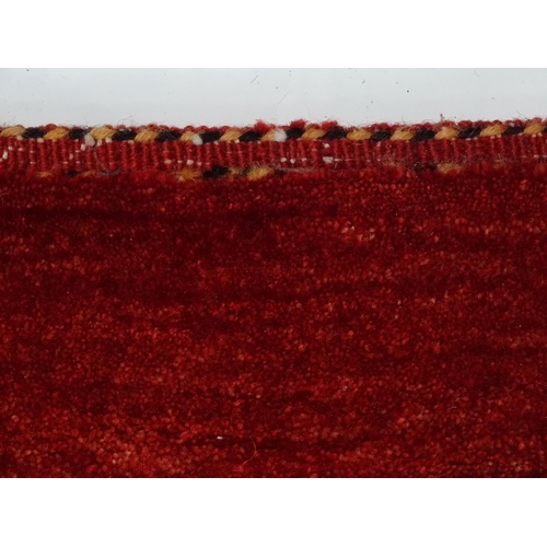 1350 - Carpet / Rug : A large carpet with a red ground. Approx. 113