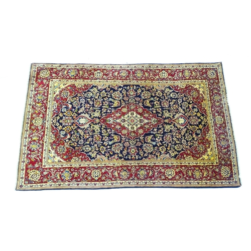 1358 - Carpet / Rug : A North West Persian Sarouk rug the red and blue ground with central floral vignette ... 