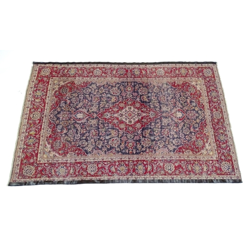 1358 - Carpet / Rug : A North West Persian Sarouk rug the red and blue ground with central floral vignette ... 