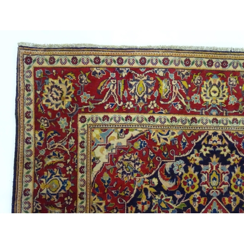 1358 - Carpet / Rug : A North West Persian Sarouk rug the red and blue ground with central floral vignette ... 