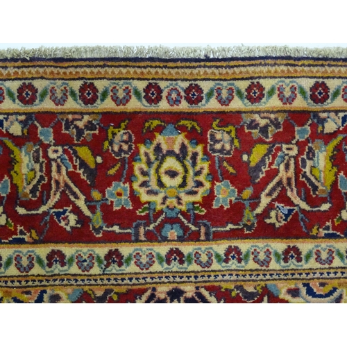 1358 - Carpet / Rug : A North West Persian Sarouk rug the red and blue ground with central floral vignette ... 