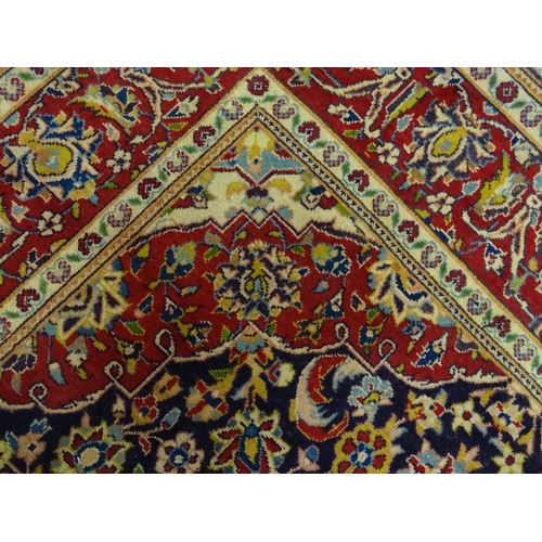 1358 - Carpet / Rug : A North West Persian Sarouk rug the red and blue ground with central floral vignette ... 