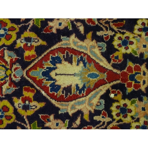 1358 - Carpet / Rug : A North West Persian Sarouk rug the red and blue ground with central floral vignette ... 