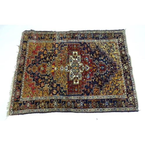 1363 - Carpet / Rug : A blue and red ground rug with floral and geometric motifs, with banded borders. Appr... 