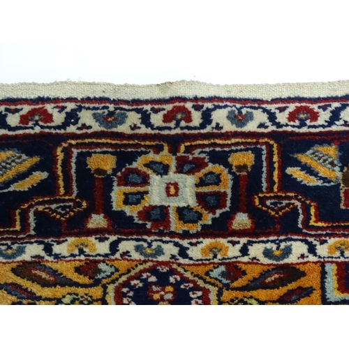 1363 - Carpet / Rug : A blue and red ground rug with floral and geometric motifs, with banded borders. Appr... 