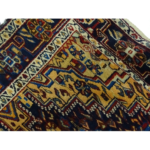 1363 - Carpet / Rug : A blue and red ground rug with floral and geometric motifs, with banded borders. Appr... 