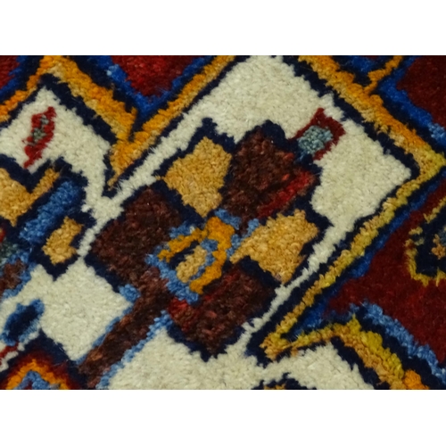 1363 - Carpet / Rug : A blue and red ground rug with floral and geometric motifs, with banded borders. Appr... 