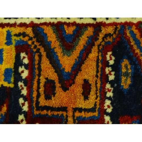 1363 - Carpet / Rug : A blue and red ground rug with floral and geometric motifs, with banded borders. Appr... 