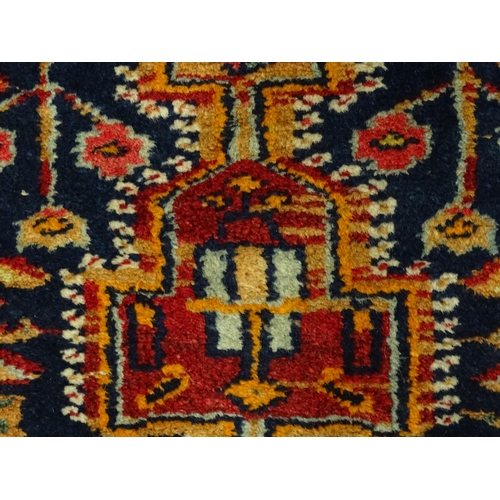 1363 - Carpet / Rug : A blue and red ground rug with floral and geometric motifs, with banded borders. Appr... 