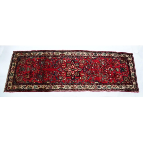 1378 - Carpet / Rug : A North West Persian Mahal runner the red ground with scrolling floral motifs and ban... 