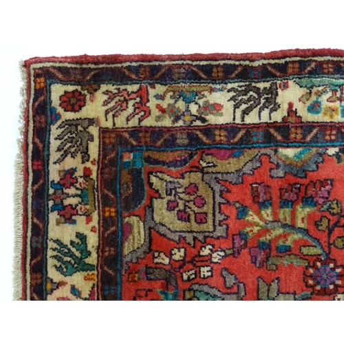 1378 - Carpet / Rug : A North West Persian Mahal runner the red ground with scrolling floral motifs and ban... 