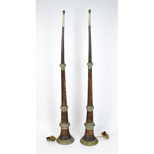 1431 - A pair of 20thC standard lamps formed from copper and brass Tibetan ceremonial trumpets. Approx. 64