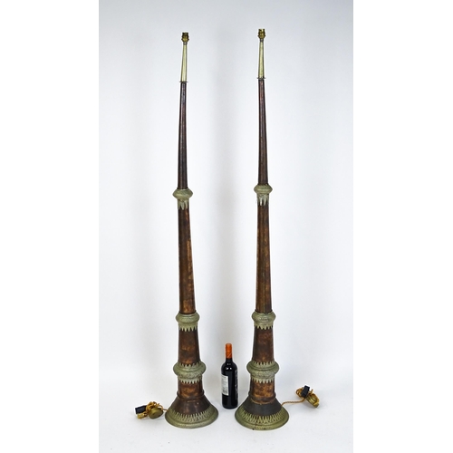 1431 - A pair of 20thC standard lamps formed from copper and brass Tibetan ceremonial trumpets. Approx. 64