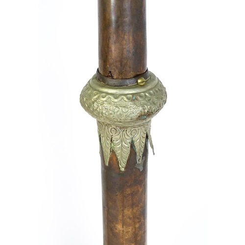 1431 - A pair of 20thC standard lamps formed from copper and brass Tibetan ceremonial trumpets. Approx. 64