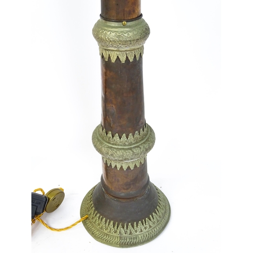 1431 - A pair of 20thC standard lamps formed from copper and brass Tibetan ceremonial trumpets. Approx. 64