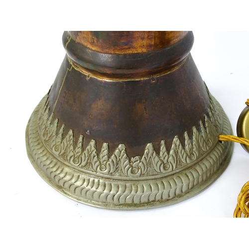 1431 - A pair of 20thC standard lamps formed from copper and brass Tibetan ceremonial trumpets. Approx. 64