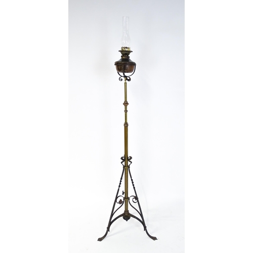 1432 - An Arts & Crafts telescopic standard lamp with oil lamp to top and cast iron base. Approx. 71