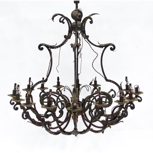 1433 - A pendant chandelier / electrolier having  sixteen scrolling branches with acanthus detail and lustr... 