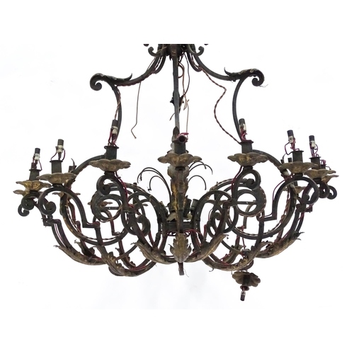 1433 - A pendant chandelier / electrolier having  sixteen scrolling branches with acanthus detail and lustr... 