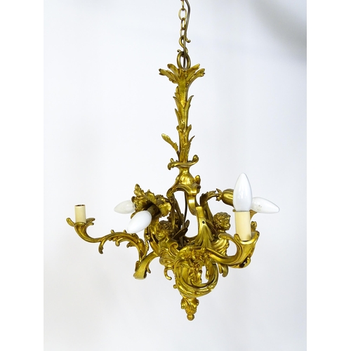 1435 - A gilt metal pendant chandelier / electrolier with acanthus scroll and cherub detail, having three c... 