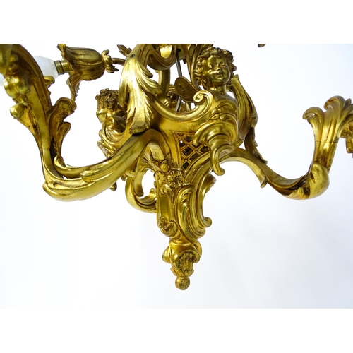 1435 - A gilt metal pendant chandelier / electrolier with acanthus scroll and cherub detail, having three c... 