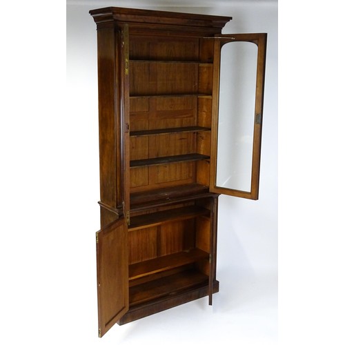 1457 - A 19thC mahogany bookcase with a moulded cornice and two glazed doors with arched panels, the base h... 