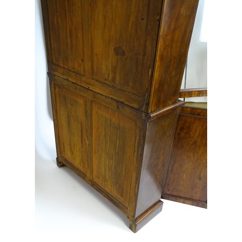 1457 - A 19thC mahogany bookcase with a moulded cornice and two glazed doors with arched panels, the base h... 