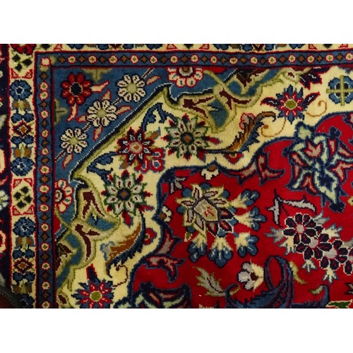 1376 - Carpet / Rug : A Central Persian Isafhan rug the red ground with central blue floral motif, further ... 