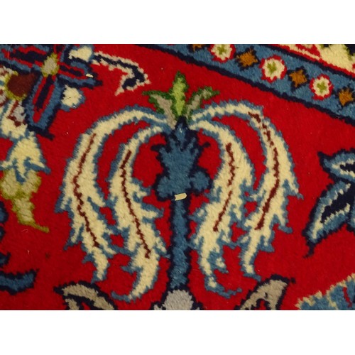 1376 - Carpet / Rug : A Central Persian Isafhan rug the red ground with central blue floral motif, further ... 