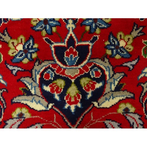 1376 - Carpet / Rug : A Central Persian Isafhan rug the red ground with central blue floral motif, further ... 