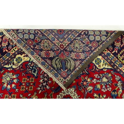 1376 - Carpet / Rug : A Central Persian Isafhan rug the red ground with central blue floral motif, further ... 