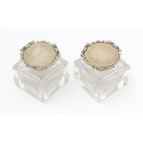 484A - A pair of glass inkwells with silver tops hallmarked London 1928, maker Mappin & Webb Ltd. Approx. 2... 