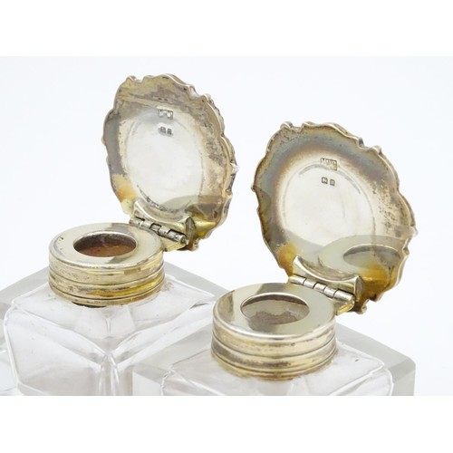 484A - A pair of glass inkwells with silver tops hallmarked London 1928, maker Mappin & Webb Ltd. Approx. 2... 