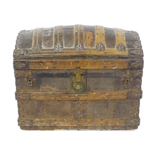 1582 - An early 20thC continental dome top trunk, with fitted interior and applied decorative lining. Appro... 