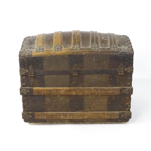 1582 - An early 20thC continental dome top trunk, with fitted interior and applied decorative lining. Appro... 