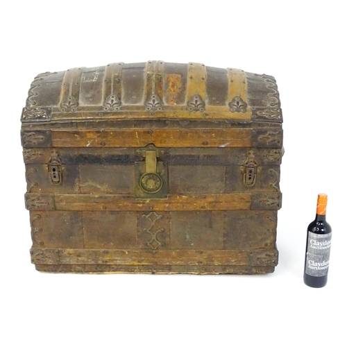 1582 - An early 20thC continental dome top trunk, with fitted interior and applied decorative lining. Appro... 