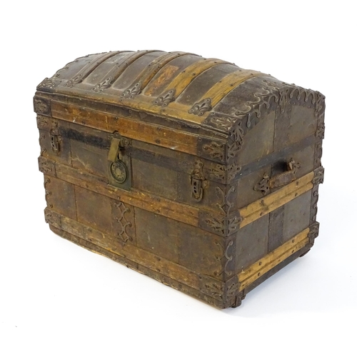 1582 - An early 20thC continental dome top trunk, with fitted interior and applied decorative lining. Appro... 