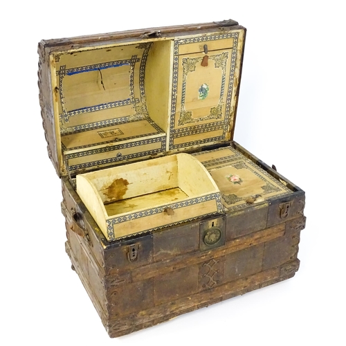 1582 - An early 20thC continental dome top trunk, with fitted interior and applied decorative lining. Appro... 