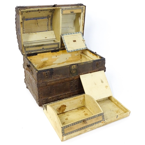 1582 - An early 20thC continental dome top trunk, with fitted interior and applied decorative lining. Appro... 