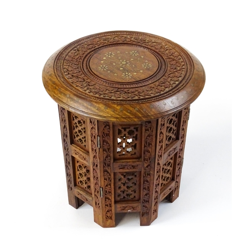 1584 - A mid 20thC Oriental style table with fretwork decoration and carved foliate detail. Approx. 13