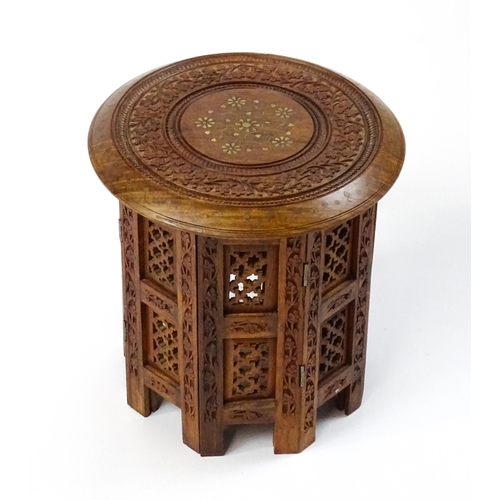 1584 - A mid 20thC Oriental style table with fretwork decoration and carved foliate detail. Approx. 13