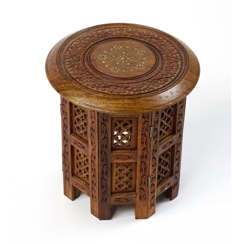 1584 - A mid 20thC Oriental style table with fretwork decoration and carved foliate detail. Approx. 13