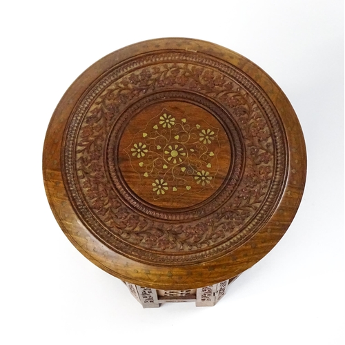 1584 - A mid 20thC Oriental style table with fretwork decoration and carved foliate detail. Approx. 13