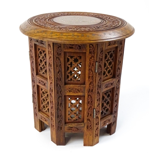 1584 - A mid 20thC Oriental style table with fretwork decoration and carved foliate detail. Approx. 13