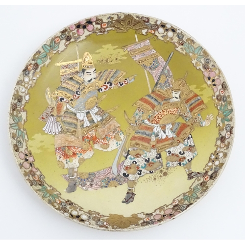 204 - A Japanese Satsuma charger decorated with two Samurai warriors. Character marks under. Approx. 12 1/... 