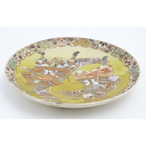 204 - A Japanese Satsuma charger decorated with two Samurai warriors. Character marks under. Approx. 12 1/... 